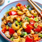 Easy Cashew Chicken Stir Fry served in a bowl, garnished with green onions