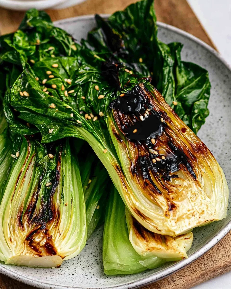 Delicious grilled bok choy served on a plate with a flavorful glaze.