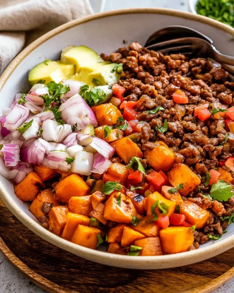 Healthy ground beef bowl recipe with vegetables and quinoa