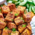 Delicious roasted salmon bites garnished and served on a plate